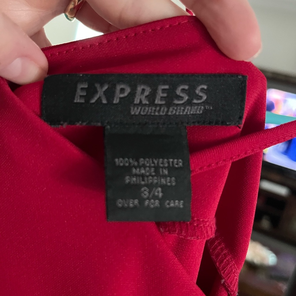 Red polyester dress that ties at shoulders. Really cute alone or with a jacket!